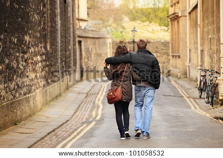 young couple walking in the old city Royalty-Free Stock Photo #101058532