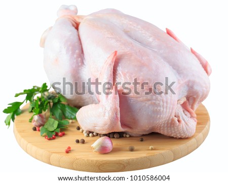 raw chicken carcass on the cutting board isolated on white background Royalty-Free Stock Photo #1010586004