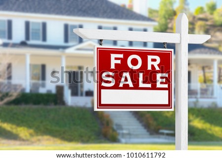 Left Facing For Sale Real Estate Sign In Front of House.
