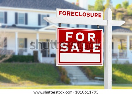 Left Facing Foreclosure For Sale Real Estate Sign in Front of House.
