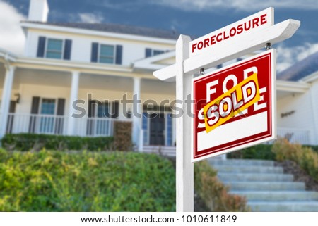 Right Facing Foreclosure Sold For Sale Real Estate Sign in Front of House.