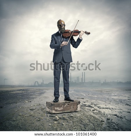 Nuclear Damage: businessman with gas mask, plays the violin Royalty-Free Stock Photo #101061400