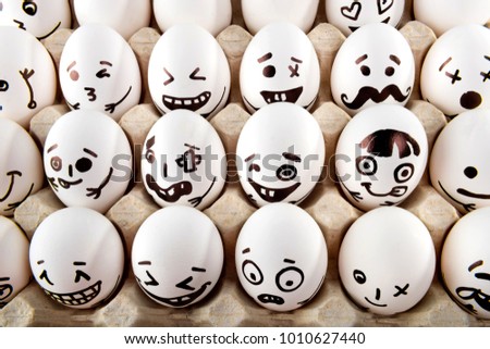 Eggs with drawn cartoon faces in tray. Easter postcard.