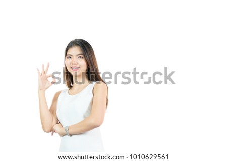 Closed up portrait of cheerful happy excited asian woman wearing a white casual and showing ok sign with beaming smile, clean skin and smooth straight black hair. isolated on white background