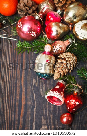 Vintage Christmas ornaments, tree branches and other decorations on the wooden background. New Year background. The concept of the winter holidays.