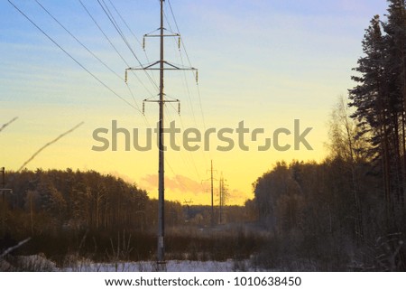 Power line in winter at sunset.