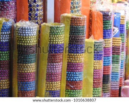 Beautiful colorful Bangles in market. Hands wearing Jewellery, Indian tradition girls and women wears color bangles