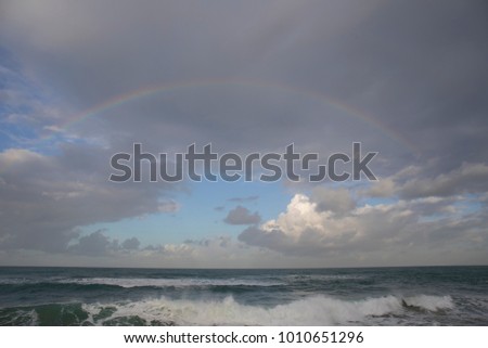 A rainbow over the ocean on a winter day
