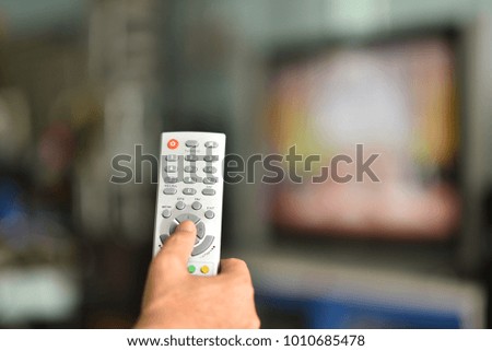 remote control in hand for satellite receiver box tv Thailand.