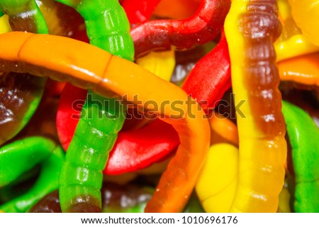 worms gummy candies, sweets in shape of bottles . Top view. Sweet background