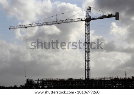 Construction crane on site, men at work.