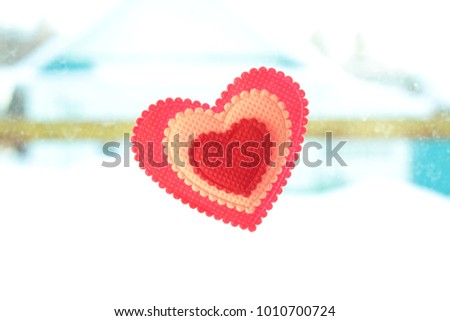 A beautiful heart glued to the window glass. Valentine's Day. Close-up. Background. Texture.