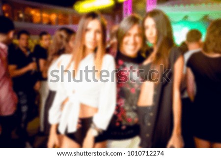Blurred for background night club. People smiling and posing on cam during concert in night club party. Man and woman have fun at club. Boy and girl at night club party