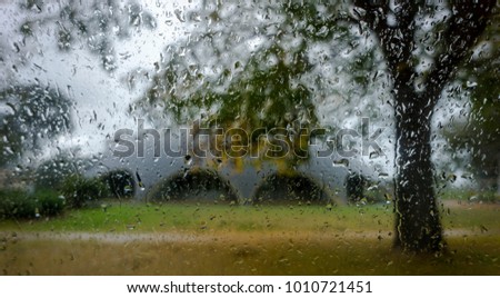 The Shrine Dome viewed from Edinburgh Avenue, Canberra, Australia, on a stormy autumn day. Rain distorts image through the car's window to reveal a swirling impressionist art effect.