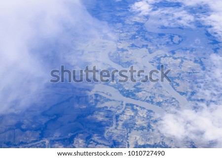 Abstract blur aerial view sky landscape and river background texture by window plane
