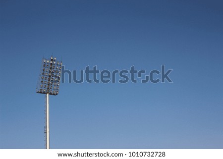 Spotlights in football stadium background, blue sky texture, copy space
