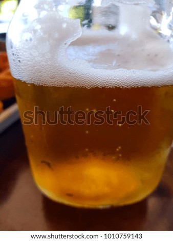 Beer in a glass jug on a restaurant background.