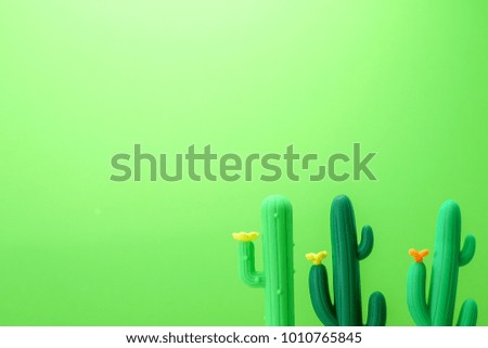 Cute and funny green rubber toy cactus. Creative concept for environmental idea or daily use background.