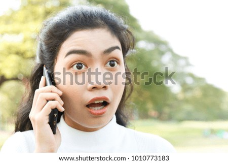 close up beauty asian woman in white shirt and use smartphone on blur background