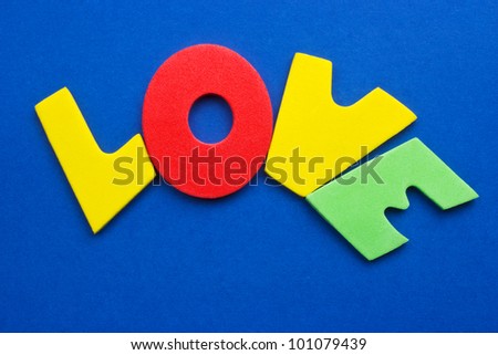 love, colored letters on blue background