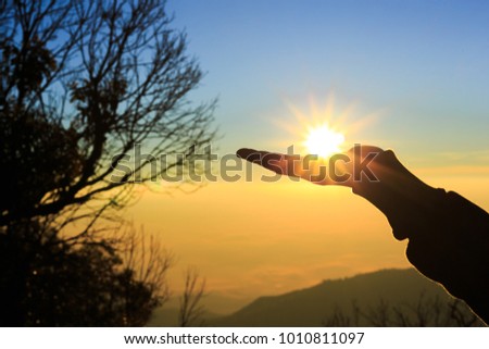Couple holding by hands on beautiful sunset