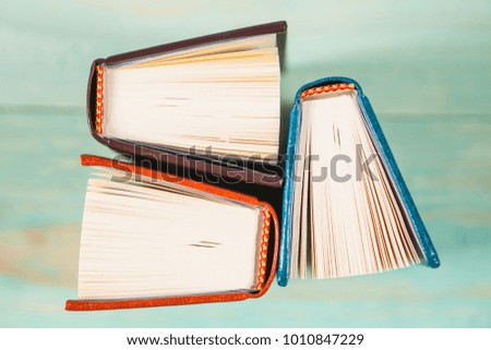 Pile of miniature books on wooden background. With copy space for your text