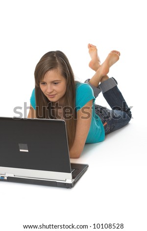 Young girl lying down on the floor with her laptop