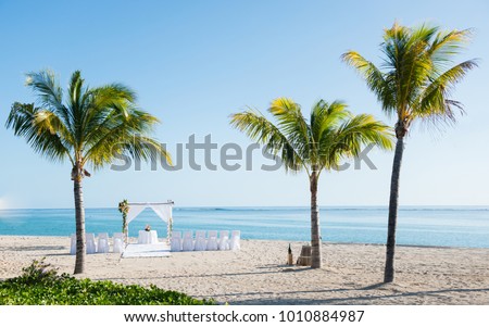 Sunny picture of beautiful and exotic wedding altar, on tropical beach of Mauritius Island with gorgeous view on the sea