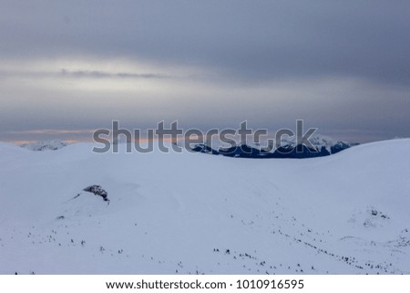 Beautiful mountains landscape with snow valley and sun