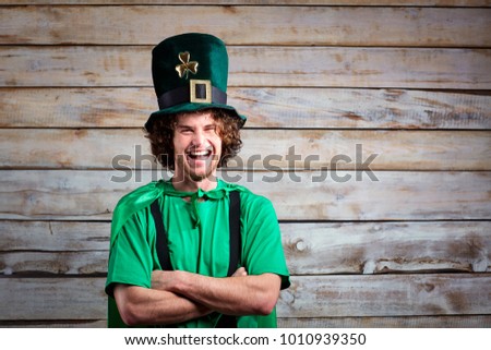 Curly funny man in St. Patrick's hat .