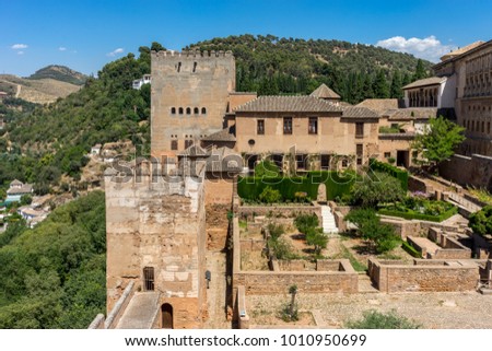 View of the Nasrid Palaces (Palacios Nazaries)  in Alhambra, Granada on a beautiful summer day, Spain, Europe, clear blue sky