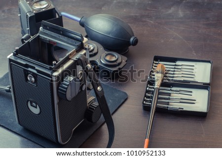 Vintage look of medium format camera cleaning.