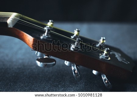 part of the guitar, neck and headstock on black background picture