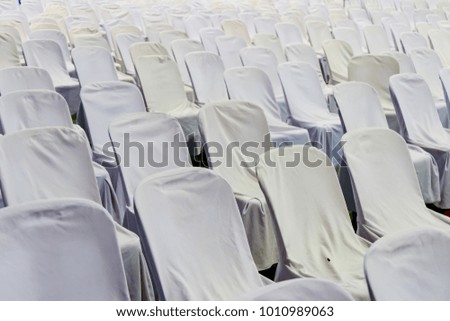 The chairs sit in a row in the auditorium.