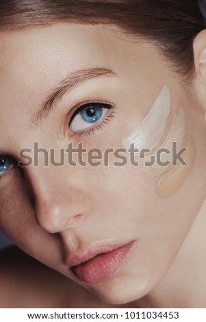 close up woman with foundation Royalty-Free Stock Photo #1011034453