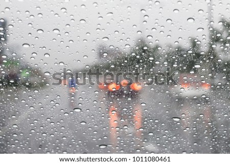 Street view through car window with rain