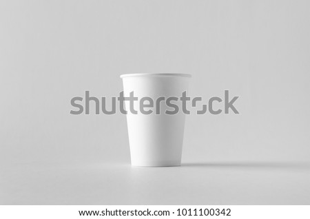 12 oz. white coffee paper cup mock-up without lid. Royalty-Free Stock Photo #1011100342