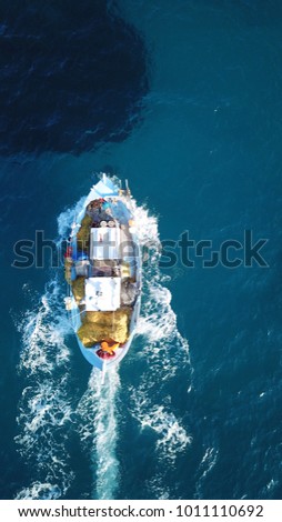 Aerial photo of traditional fishing boat cruising island of Crete, Greece