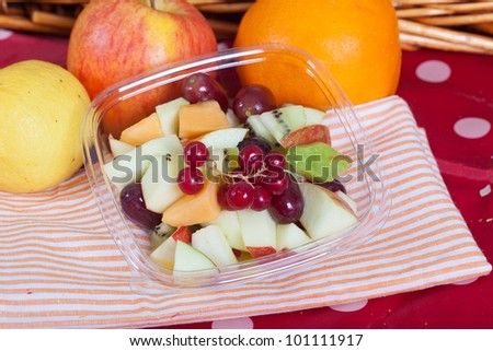 Fresh summer fruit salad with ribes, apple, kiwi, grapes and melon