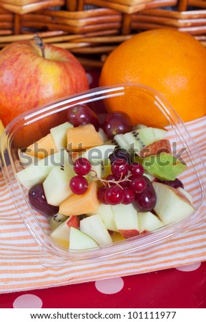 Fresh summer fruit salad with ribes, apple, kiwi, grapes and melon