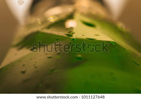 a bottle of beer and water drop close up