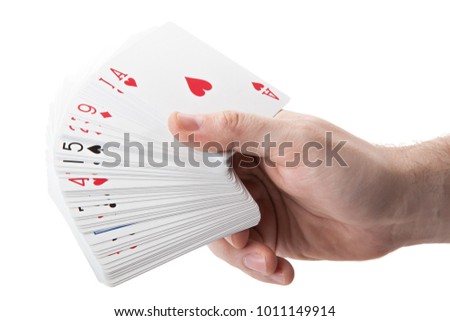 fan of playing cards in hand on a white background isolated