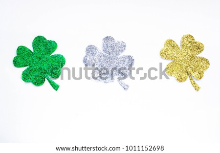 Golden, green and silver clover leaf isolated on white background. St. Patrick day concept.