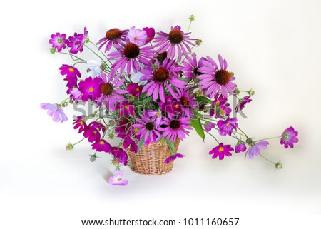 Still life with wildflowers in a clay pot on a wooden table .A bouquet of red and white flowers