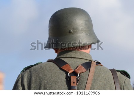 soldier in a green uniform and helmet