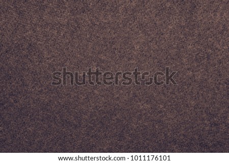 the macrophotography of fabric of a velvet of lilac color for the abstract textured background or for wallpaper