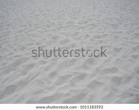 View of beach sand with imprints from footsteps 