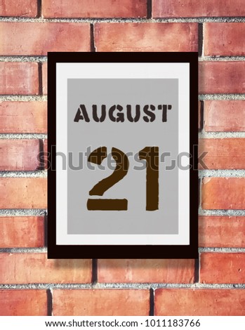 August 21st. 21 August calendar on the wood photo frame with brown brick background. Summer day