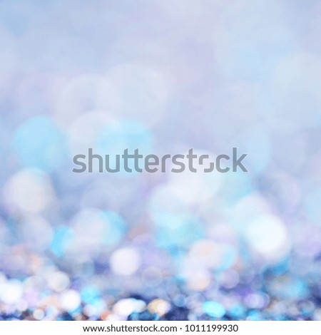 Abstract blue colored background composition made of pile of tinsel shot in bokeh as a backdrop