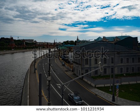 A street across the moscow river from the kremlin on a summer day. 